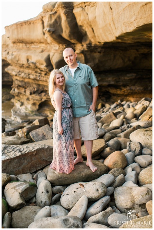 Happy couple by the cave | La Jolla Cove Beach Engagement Photo | San Diego Engagement Wedding Photographer | Kristine Marie Photography © www.kristinemariephotography.com (6)