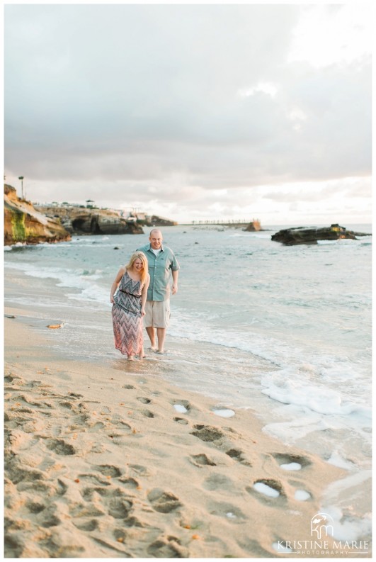 Couple playing in the water | La Jolla Cove Beach Engagement Photo | San Diego Engagement Wedding Photographer | Kristine Marie Photography © www.kristinemariephotography.com (14)