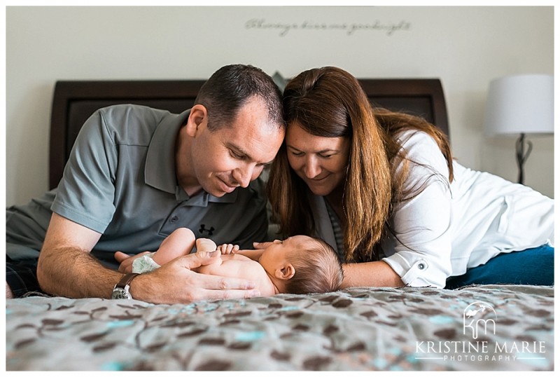Mom and Dad with Newborn Baby on Bed | | San Diego Newborn Baby Photographer | Kristine Marie Photography © www.kristinemariephotography.com