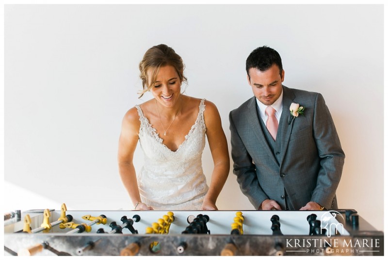 Bride and groom playing foosball | Scripps Seaside Forum Wedding | La Jolla San Diego Wedding Photographer | Kristine Marie Photography | © www.kristinemariephotography.com