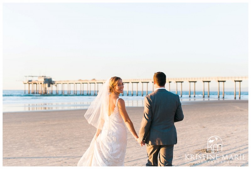 bride and groom head to scripps pier | Scripps Seaside Forum Wedding | La Jolla San Diego Wedding Photographer | Kristine Marie Photography | © www.kristinemariephotography.com