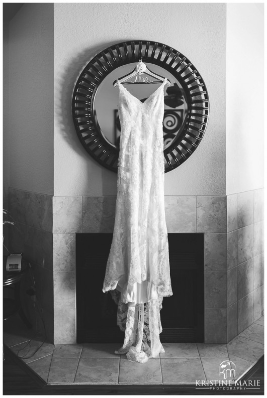 Lace wedding dress over the fireplace | Scripps Seaside Forum Wedding | La Jolla San Diego Wedding Photographer | Kristine Marie Photography | © www.kristinemariephotography.com