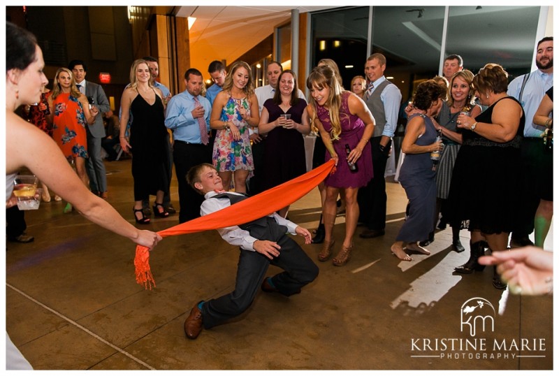 Limbo dance wedding reception | Scripps Seaside Forum Wedding | La Jolla San Diego Wedding Photographer | Kristine Marie Photography | © www.kristinemariephotography.com