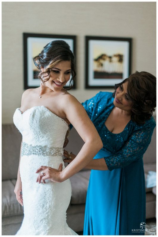 Bride getting zipped up into dress by her mom | Scripps Seaside Forum Wedding Photo | Beach Elegance | © Kristine Marie Photography www.kristinemariephotography.com (68)