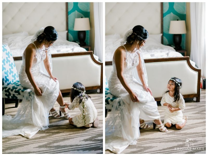 Flower girl helping bride put on shoes | Kona Kai Resort Wedding Picture | San Diego | © Kristine Marie Photography