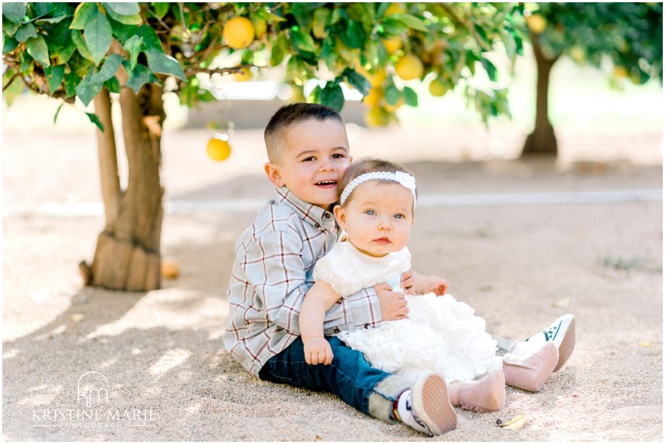 Little boy holding little sister lemon tree | Escondido Family Photographer | San Diego Fall Holiday Pictures